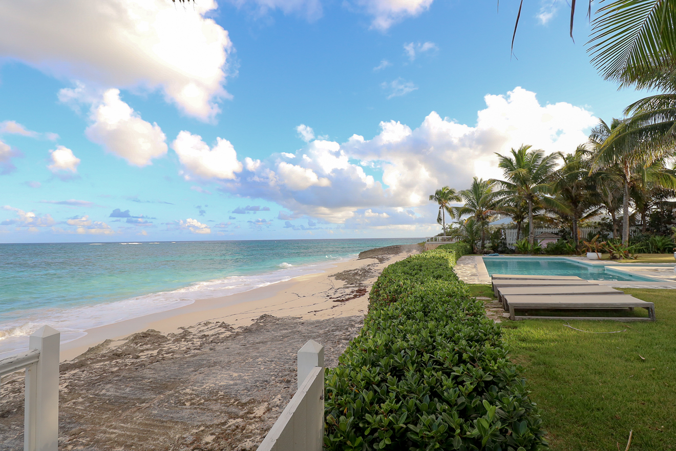 Panoramic view of the private pool, beach, and turquoise Atlantic Ocean