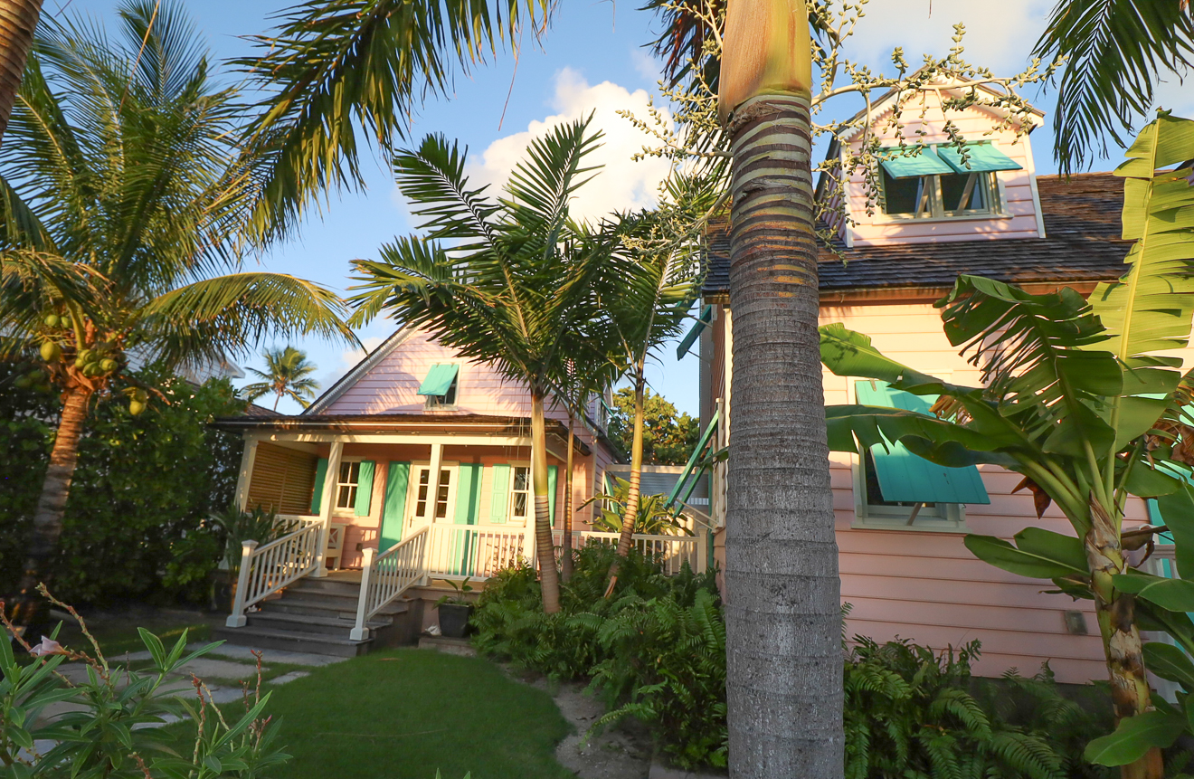 Front facades of both cottages at dusk, garden in foreground