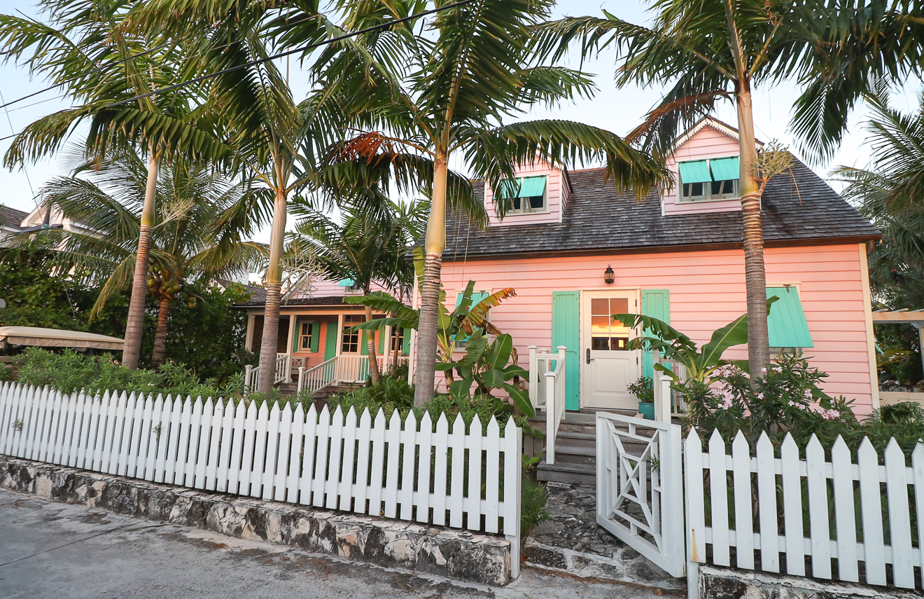 Street view of Hummingbird Cottages with white picket fence, Hope Town